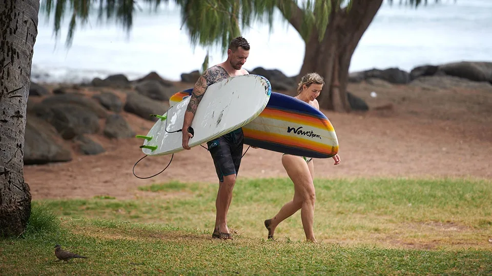 Two surfers walking out to the water