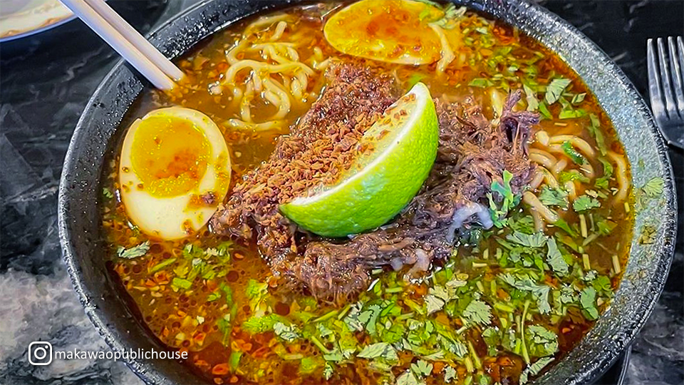 Bowl of ramen at Makawao Public House, featuring rich broth, noodles, and a variety of fresh toppings.