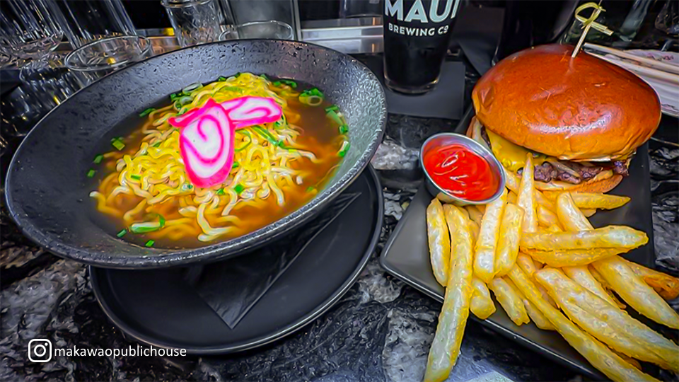 Bowl of ramen and a plate of burger and fries at Makawao Public House, featuring diverse dining options in a single meal.