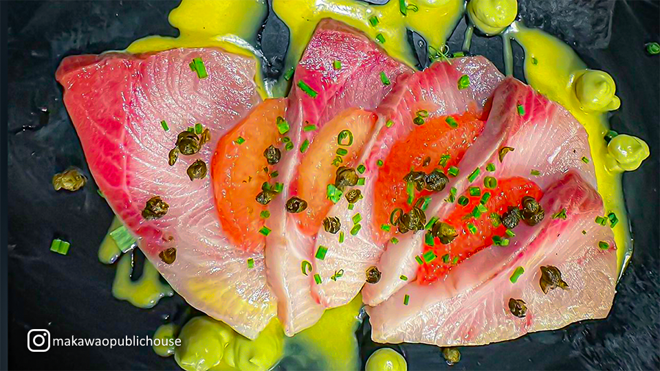 Beautifully arranged sashimi plate at Makawao Public House, highlighting vibrant cuts of fresh fish.