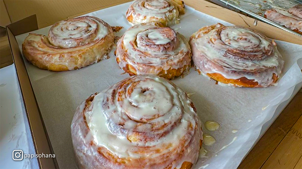 Freshly baked King David’s Cinnamon Rolls at Papi’s Ohana, served with a swirl of icing on top.