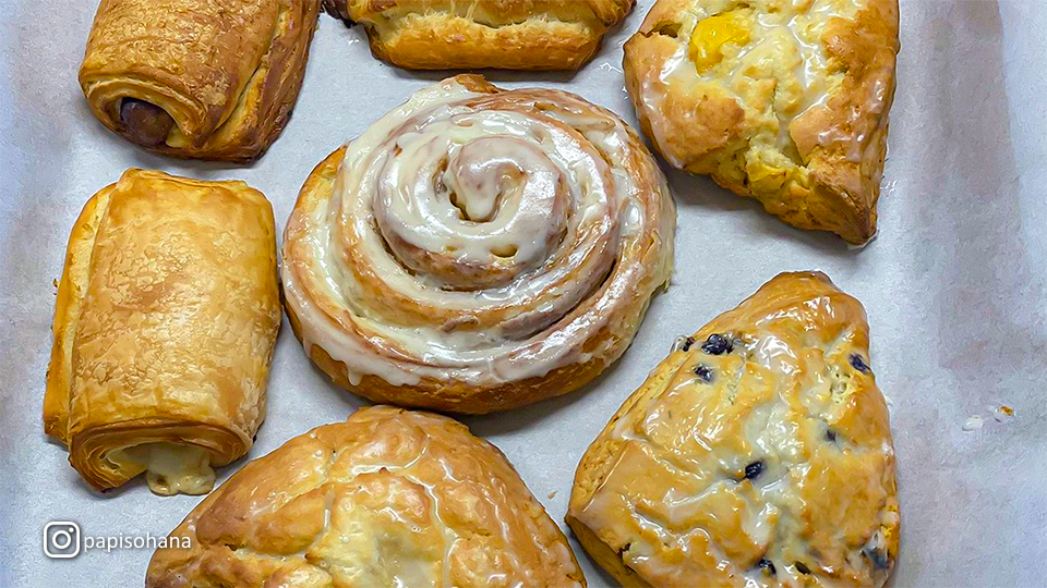 Close-up of assorted baked goods at Papi’s Ohana, including scones, croissants, and cookies.