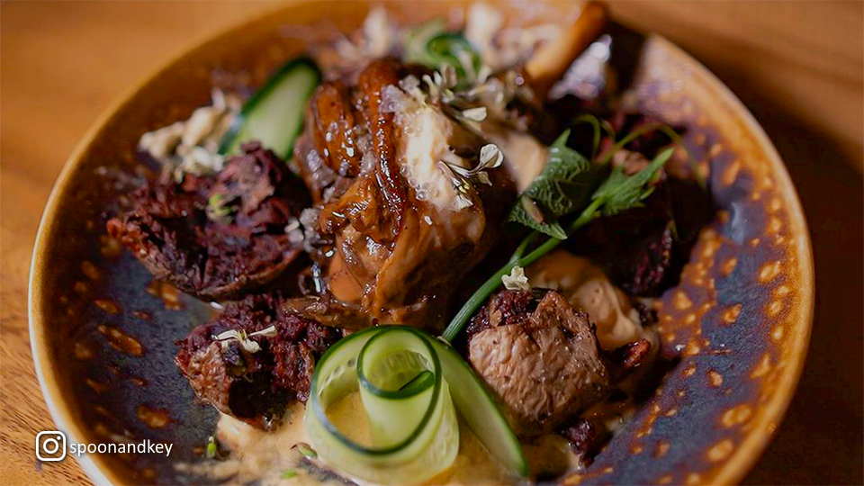 Close-up of a beautifully plated entrée at Spoon & Key Market, highlighting elegant presentation and refined ingredients.