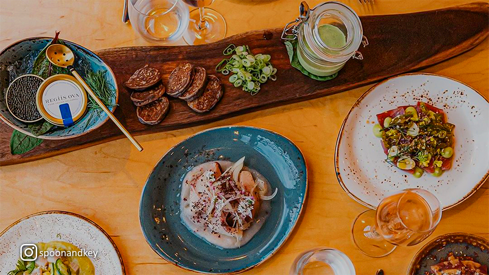 Overhead view of assorted dishes and garnishes at Spoon & Key Market, featuring vibrant colors and fresh ingredients.