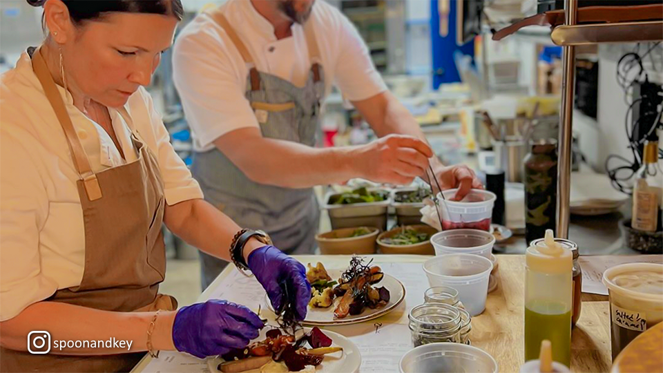 Chefs preparing and plating dishes at Spoon & Key Market, emphasizing attention to detail and creativity.