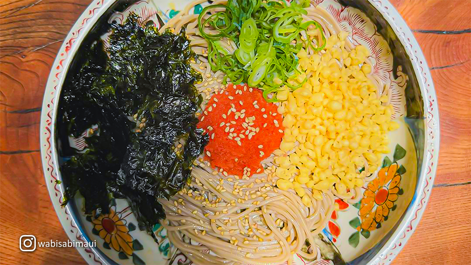 Hot soba noodle soup at Wabisabi Soba & Sushi in Paia, Maui, served with tender slices of meat and fresh vegetables.