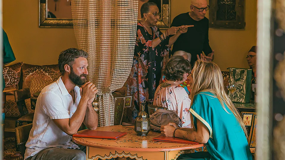 Two guests at a table, showcasing Le Bazaar Maui's intricate design details and cozy ambiance.