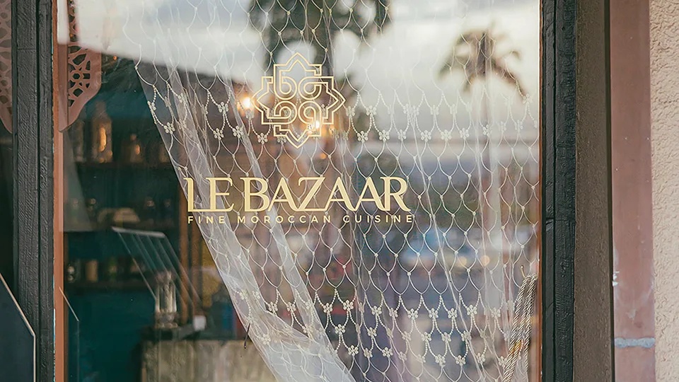 Close-up of Le Bazaar Maui’s business name on the entrance door with stylish lettering.