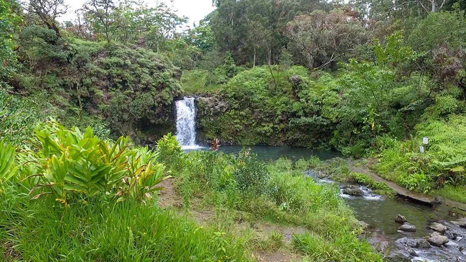 Pua'a Ka'a Falls cascading through lush vegetation at Mile Marker 22 on Road to Hana Maui