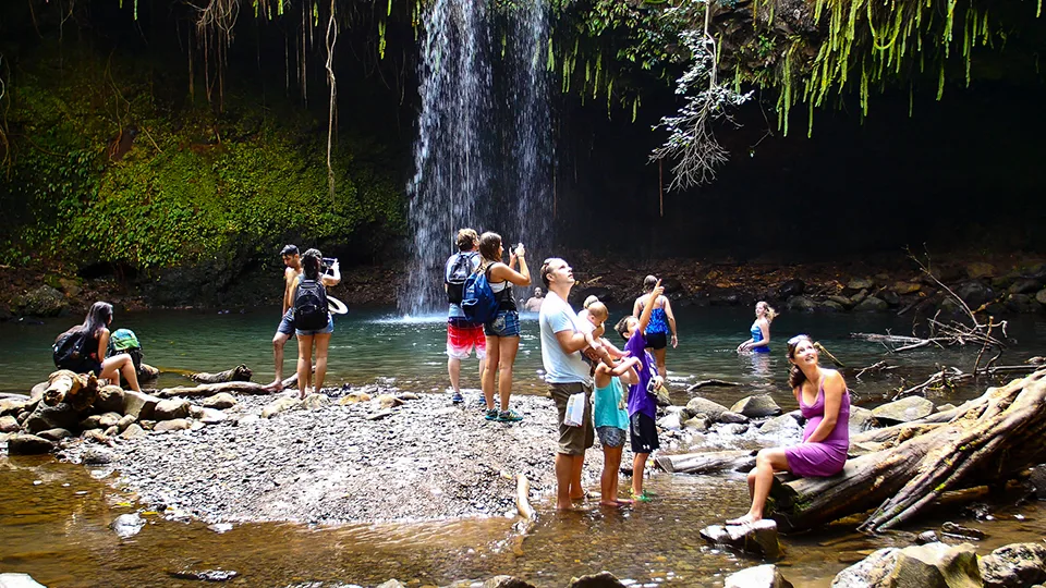 Families enjoying Twin Falls swimming pools perfect family-friendly waterfall stop on Road to Hana