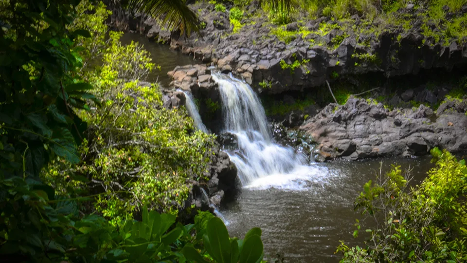 Intimate waterfall view at 'Ohe'o Gulch Seven Sacred Pools with volcanic rock formations Maui