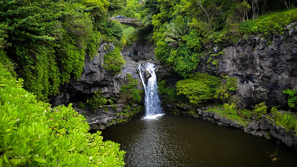 Secluded waterfall at 'Ohe'o Gulch Seven Sacred Pools surrounded by tropical forest Maui