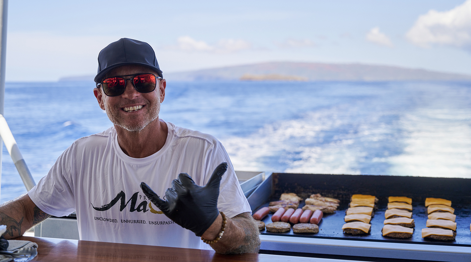 cooking food on grill with Molokini in background