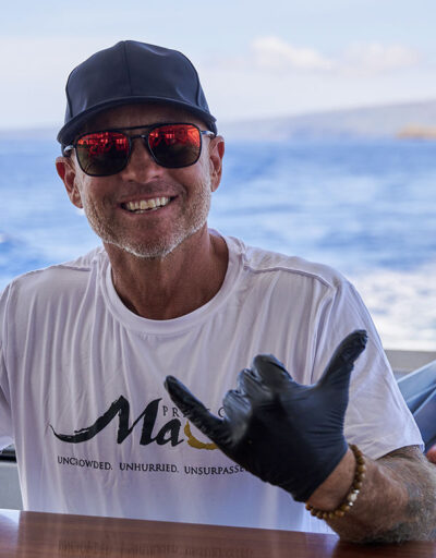 cooking food on grill with Molokini in background